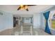 Sunroom featuring a glass table, tile floors, ceiling fan, and views of the yard at 156 Myakka Rd, Venice, FL 34293