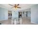 Bright sunroom, tile flooring, glass table, ceiling fan, laundry room access at 156 Myakka Rd, Venice, FL 34293