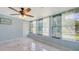 Inviting sunroom featuring marble tile floors and natural light from the big windows at 156 Myakka Rd, Venice, FL 34293
