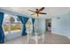 Bright sunroom with tile floors, ceiling fan, glass table, and views of the lawn at 156 Myakka Rd, Venice, FL 34293
