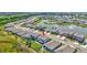 Aerial view of a home with a backyard, nearby pond and residential area at 17330 Harvest Moon Way, Bradenton, FL 34211