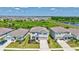 Aerial view of a home in a suburban neighborhood, showcasing the property's proximity to a pond and green space at 17330 Harvest Moon Way, Bradenton, FL 34211