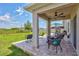 Covered back patio with brick pavers, ceiling fan and view of large fenced-in yard at 17330 Harvest Moon Way, Bradenton, FL 34211