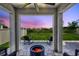 Back patio at dusk with a lit fire pit and a view of the backyard at 17330 Harvest Moon Way, Bradenton, FL 34211