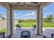 Covered back patio with brick pavers, ceiling fan and fire pit at 17330 Harvest Moon Way, Bradenton, FL 34211