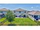 A well-kept backyard with a patio, green lawn, and a black metal fence at 17330 Harvest Moon Way, Bradenton, FL 34211