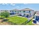 Backyard featuring a green lawn, patio area, and fenced perimeter providing privacy and security at 17330 Harvest Moon Way, Bradenton, FL 34211