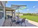 Covered outdoor patio includes ceiling fan, furnishings and view of the spacious, grassy backyard at 17330 Harvest Moon Way, Bradenton, FL 34211