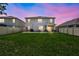 Spacious backyard during twilight, featuring privacy fencing and a patio at 17330 Harvest Moon Way, Bradenton, FL 34211