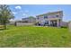 Well-maintained backyard with a concrete patio and outdoor seating, perfect for entertaining guests at 17330 Harvest Moon Way, Bradenton, FL 34211