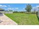 Large backyard featuring lush green grass, privacy fence, and brick patio at 17330 Harvest Moon Way, Bradenton, FL 34211
