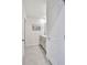 Bright bathroom featuring tiled floors, white cabinets and marble countertops at 17330 Harvest Moon Way, Bradenton, FL 34211