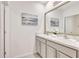Bright bathroom featuring double sinks, marble countertops and a decorative mirror at 17330 Harvest Moon Way, Bradenton, FL 34211