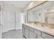 Bright bathroom with a double sink vanity, a large mirror and white painted cabinets offering plenty of storage at 17330 Harvest Moon Way, Bradenton, FL 34211