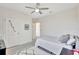 Relaxing bedroom with light gray carpet, a ceiling fan, and fun decor creates a playful and inviting space at 17330 Harvest Moon Way, Bradenton, FL 34211