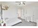 Bright bedroom with light gray carpet, a ceiling fan, and charming decor creating a cozy and inviting space at 17330 Harvest Moon Way, Bradenton, FL 34211