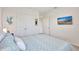 Comfortable bedroom featuring neutral décor, a double closet, and an entertainment area on the wall at 17330 Harvest Moon Way, Bradenton, FL 34211