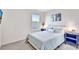 Cozy bedroom with plush carpeting, serene blue accents, and a large window for ample natural light at 17330 Harvest Moon Way, Bradenton, FL 34211