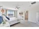 Inviting bedroom featuring carpeted floors, a window, and minimalist décor at 17330 Harvest Moon Way, Bradenton, FL 34211