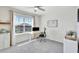 Bright bedroom featuring a large window, desk and ceiling fan at 17330 Harvest Moon Way, Bradenton, FL 34211