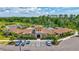 Community clubhouse featuring a pool, parking, and lush landscaping in a serene setting at 17330 Harvest Moon Way, Bradenton, FL 34211