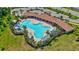 Stunning aerial view of the community pool, complemented by lush landscaping and shaded lounging areas at 17330 Harvest Moon Way, Bradenton, FL 34211