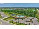 Aerial view showcases a resort-style pool, surrounded by green spaces and community amenities at 17330 Harvest Moon Way, Bradenton, FL 34211