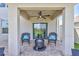 Covered patio featuring outdoor seating with view of the backyard through sliding glass doors at 17330 Harvest Moon Way, Bradenton, FL 34211