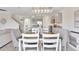 Open-concept dining area with modern chandelier and views of the updated kitchen at 17330 Harvest Moon Way, Bradenton, FL 34211
