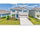 Charming two-story home with a well-manicured front yard and a welcoming entryway at 17330 Harvest Moon Way, Bradenton, FL 34211