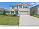 Charming two-story home with a well-manicured lawn and a two car garage at 17330 Harvest Moon Way, Bradenton, FL 34211