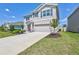 A charming two-story home featuring a manicured lawn and a two-car garage at 17330 Harvest Moon Way, Bradenton, FL 34211