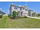 A two-story home features a manicured lawn and a two-car garage at 17330 Harvest Moon Way, Bradenton, FL 34211