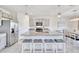 Bright kitchen boasts a large island with breakfast bar, granite countertops, and stainless steel appliances at 17330 Harvest Moon Way, Bradenton, FL 34211
