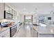Bright open kitchen and dining area featuring modern stainless steel appliances and granite countertops at 17330 Harvest Moon Way, Bradenton, FL 34211