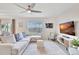 Airy living room boasting tile floors, a comfortable sectional, and a modern TV console with stylish decor at 17330 Harvest Moon Way, Bradenton, FL 34211