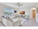 Bright living room with neutral furnishings, a ceiling fan, and a large window for natural light at 17330 Harvest Moon Way, Bradenton, FL 34211