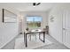 Inviting office space with a contemporary desk, plush rug, and large window bringing in natural light and fresh air at 17330 Harvest Moon Way, Bradenton, FL 34211