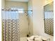 Bathroom featuring shower with neutral tile and patterned curtain, as well as vanity sink at 17605 Roanwood Ct, Parrish, FL 34219