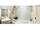 Bright bathroom featuring a shower-tub combo with white tile surround and a modern vanity with sink at 17605 Roanwood Ct, Parrish, FL 34219