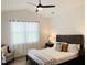 Well-lit bedroom with a ceiling fan, accent chair, a comfortable bed, and a serene atmosphere at 17605 Roanwood Ct, Parrish, FL 34219