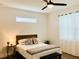 Bright bedroom featuring a ceiling fan, a neutral color palette, and a comfortable bed at 17605 Roanwood Ct, Parrish, FL 34219