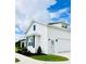 Bright exterior of a home, showcasing its white facade, well-manicured lawn, and attached garage at 17605 Roanwood Ct, Parrish, FL 34219