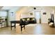 Spacious game room with comfortable sofa, foosball table, and natural light, great for entertaining at 17605 Roanwood Ct, Parrish, FL 34219