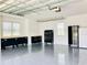 Spacious garage with epoxy flooring and storage cabinets, offering ample space for vehicles and tools at 17605 Roanwood Ct, Parrish, FL 34219