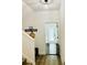 Bright hallway with light wood floors, stairs, and a protective baby gate at the doorway at 17605 Roanwood Ct, Parrish, FL 34219