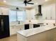 Modern kitchen featuring white cabinets, granite countertops, and stainless steel appliances at 17605 Roanwood Ct, Parrish, FL 34219