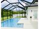 Enclosed pool area with a screen, featuring a clean pool with a lounge area, ideal for outdoor relaxation at 17605 Roanwood Ct, Parrish, FL 34219