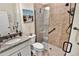 Bathroom boasts granite vanity, a modern toilet and tiled walk-in shower with black hardware and glass doors at 17725 Northwood Pl., Bradenton, FL 34202