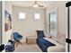 Bright, cozy bedroom with a modern daybed and chair, shuttered windows and ceiling fan at 17725 Northwood Pl., Bradenton, FL 34202